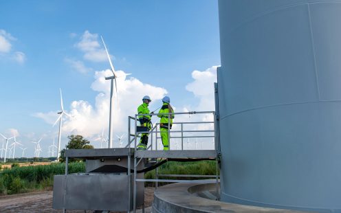 Two operators standing by wind mill